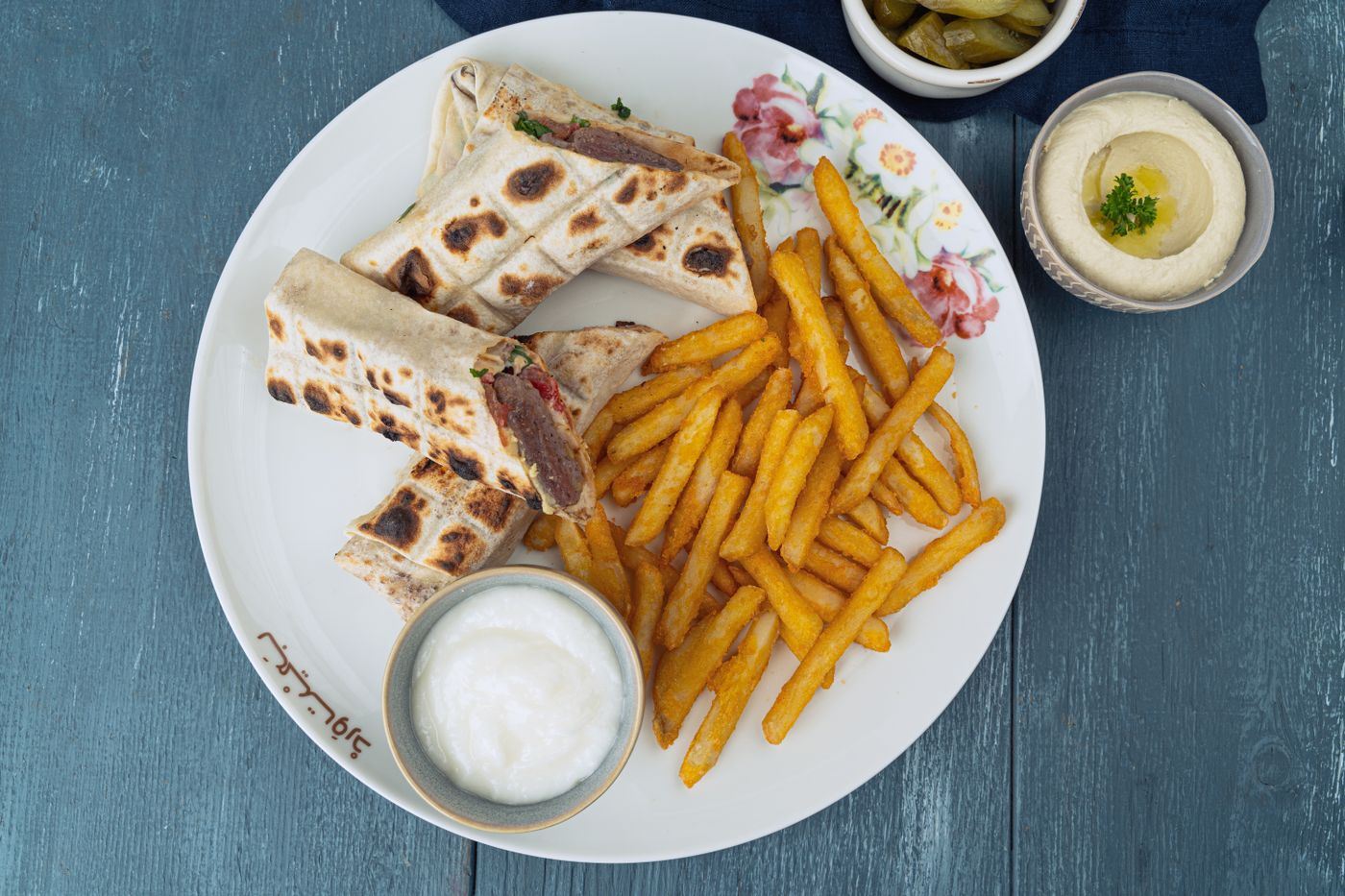 Galettes grillées servies avec des frites et de la sauce